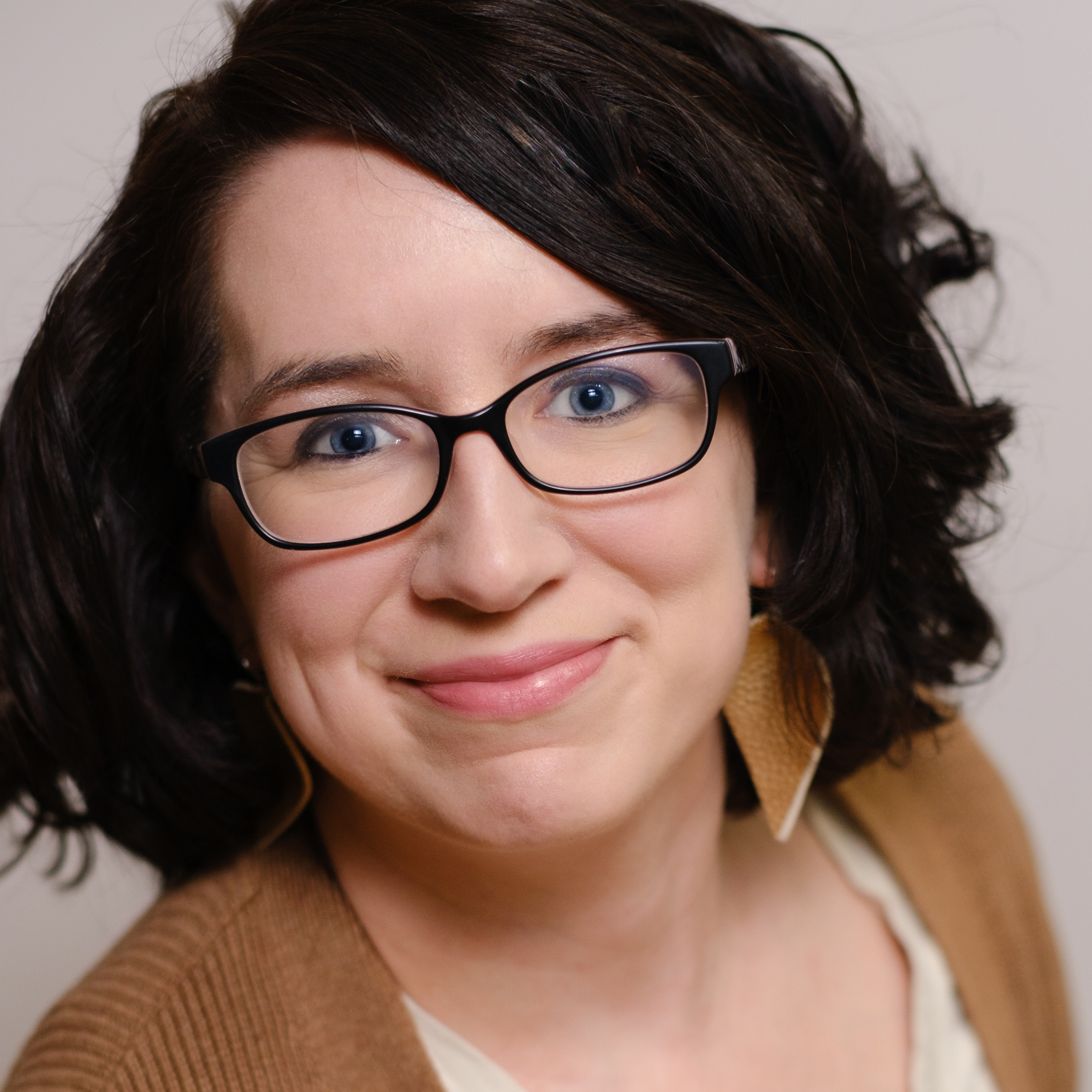 A head and shoulders portrait of writer, editor and photographer Hillary K. Grigonis.