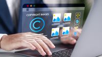 A person types on a laptop with "copyright images" on the screen